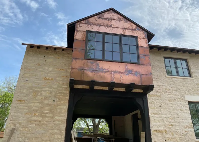 Copper metal panel facade on a stone building for Skylight Installation in Clear Lake