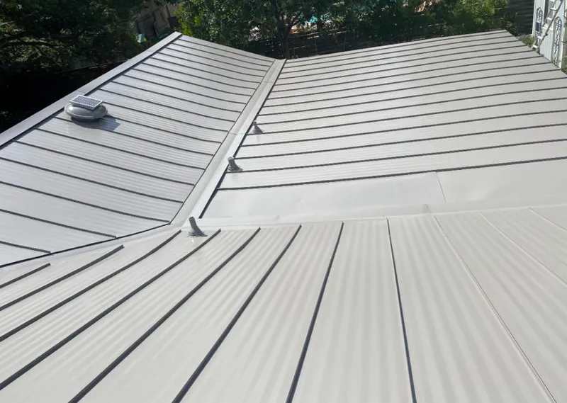 Solar attic fan installed on a metal roof for Roof Ventilation in Clear Lake